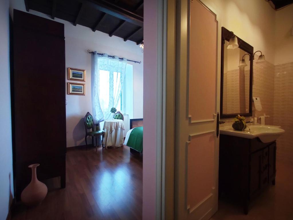 Cette chambre comprend une salle de bains pourvue d'un lavabo et d'un miroir. dans l'établissement DIMORA MARELLA Patrica - Frosinone, à Patrica