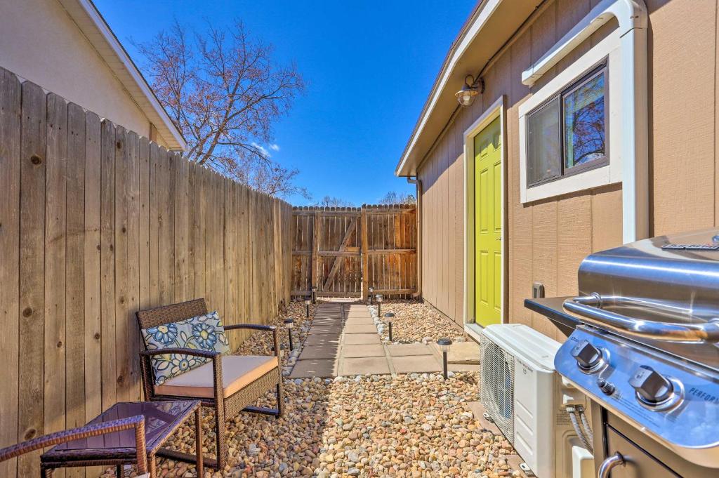 a backyard with a fence and a stove at Quaint Studio with Grill 7 Mi to Dtwn Denver! in Aurora