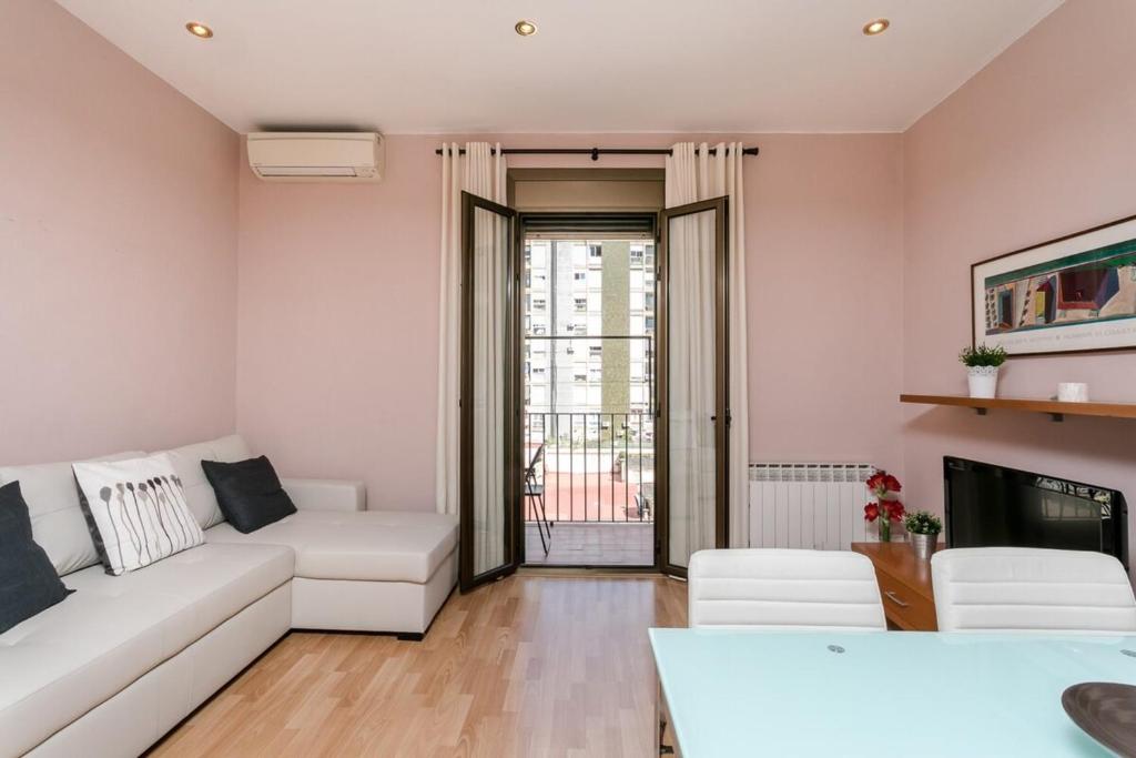 バルセロナにあるFantastic 2 Bedroom 5 minutes by car from Plaza Catalunyaのリビングルーム(白いソファ、テレビ付)