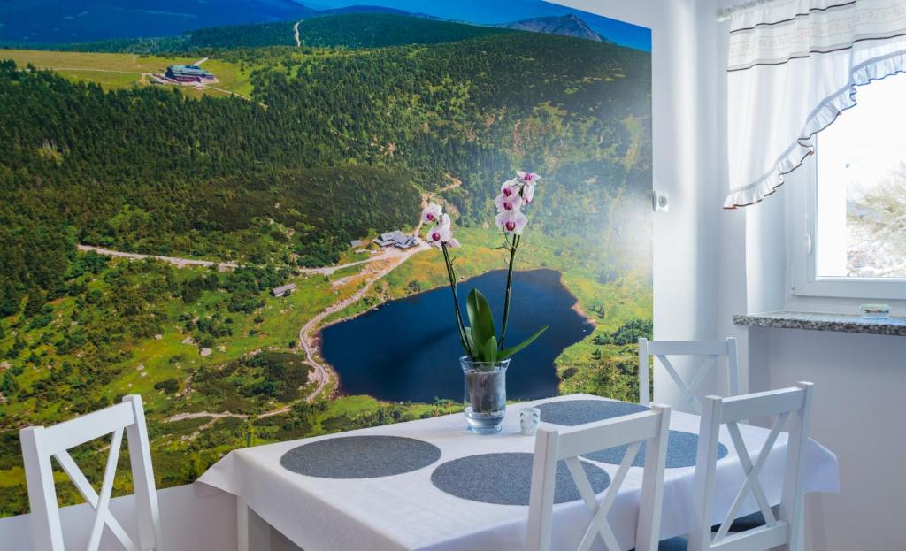 a dining room with a table with a view of a mountain at Apartament Ski Sudety Kowary in Kowary