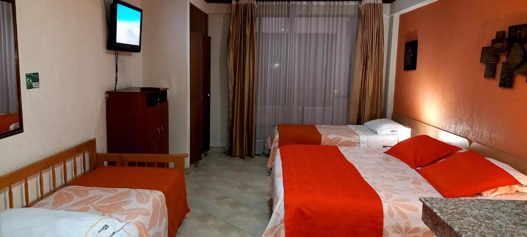 Postel nebo postele na pokoji v ubytování Hoteles Bogotá Inn Turisticas 63