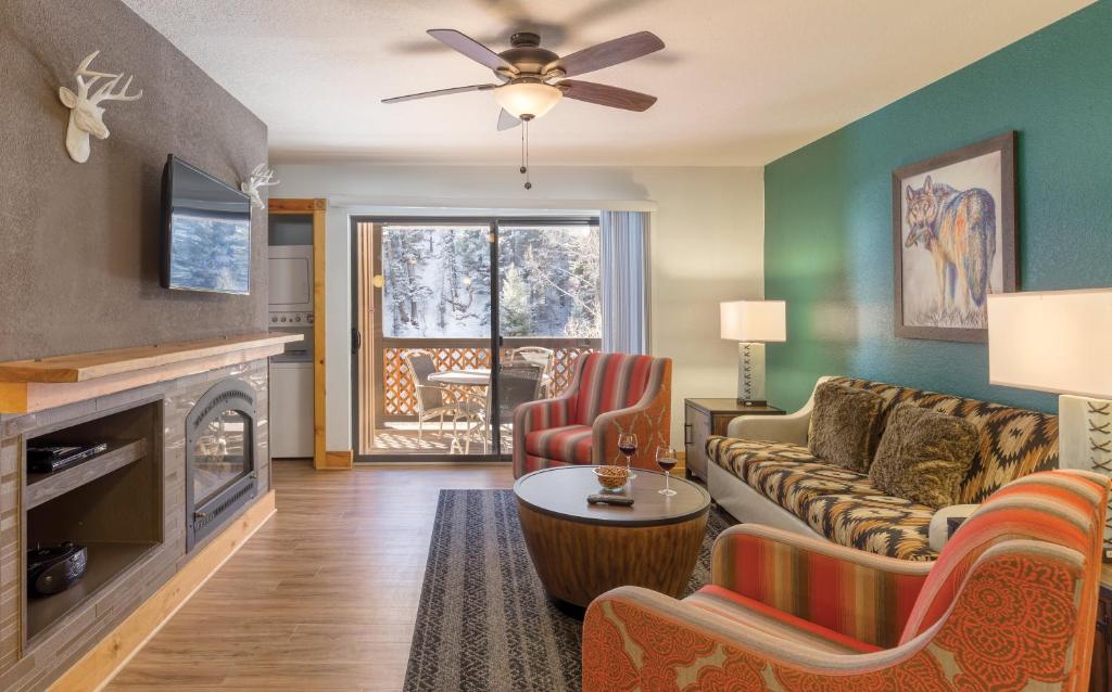 a living room with a couch and a fireplace at WorldMark Red River in Red River