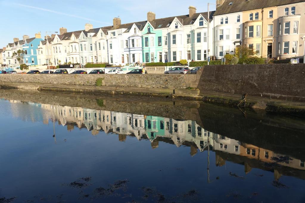 a reflection of buildings in a body of water at Period house on seafront, Bangor Co.Down in Bangor