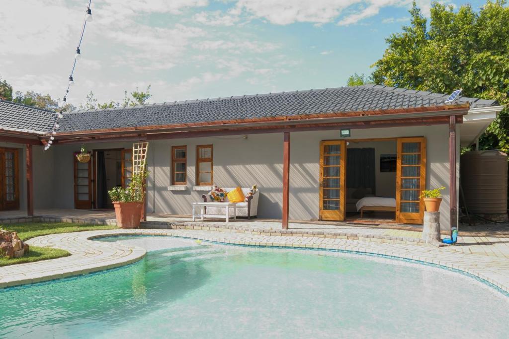 a house with a swimming pool in front of it at The Walmer Oasis in Port Elizabeth