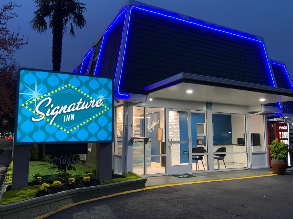 a restaurant with a sign in front of it at Signature Inn Eugene in Eugene