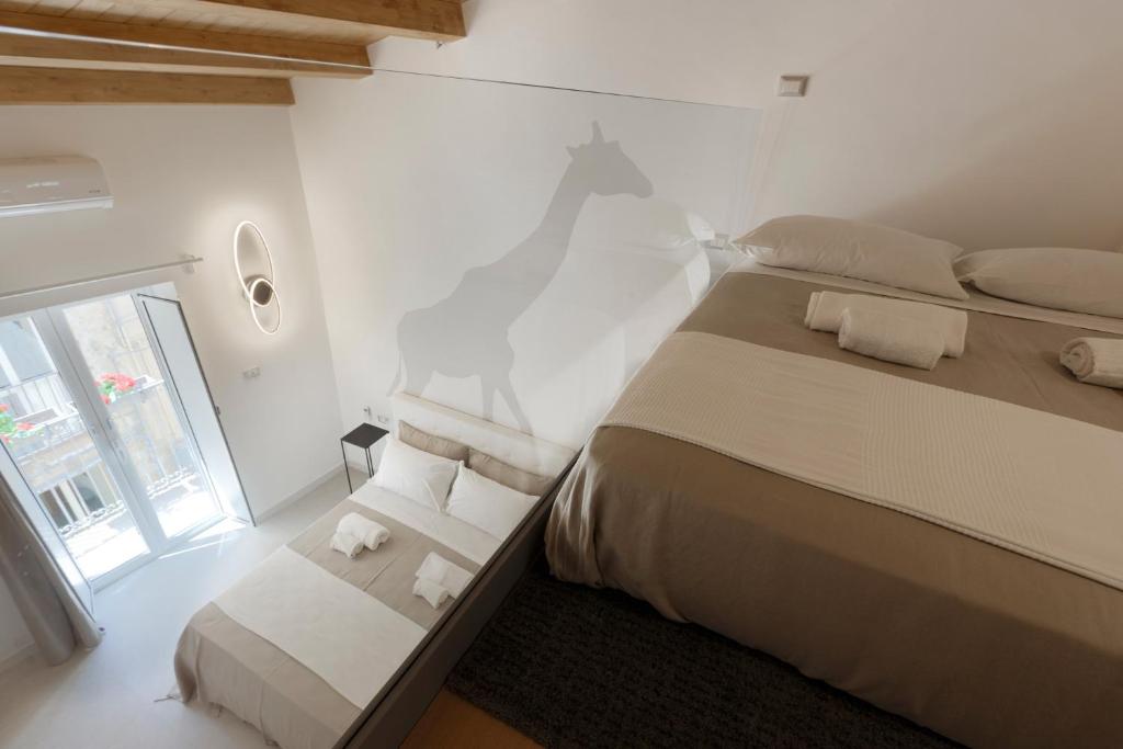 Llit o llits en una habitació de Sicily Dreams Luxury