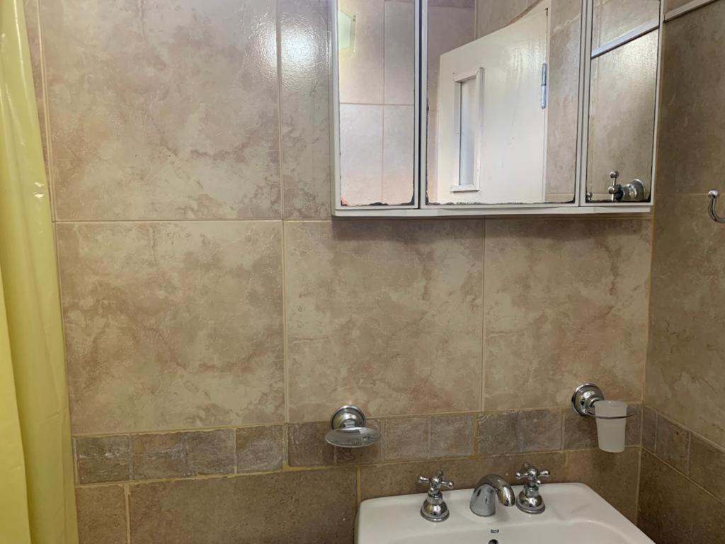 ein Badezimmer mit Waschbecken und Spiegel in der Unterkunft Multiespacio Turismo-Trabajo Av Entre Ríos in Salta