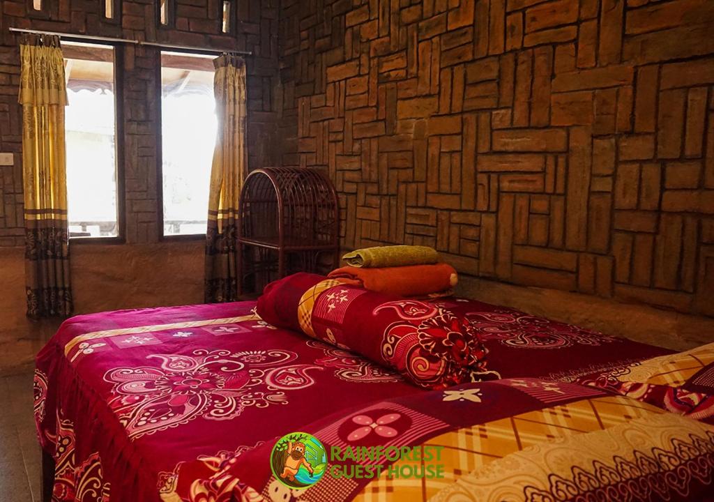 Una cama o camas en una habitación de Rain Forest Guest House and Jungle Trekking
