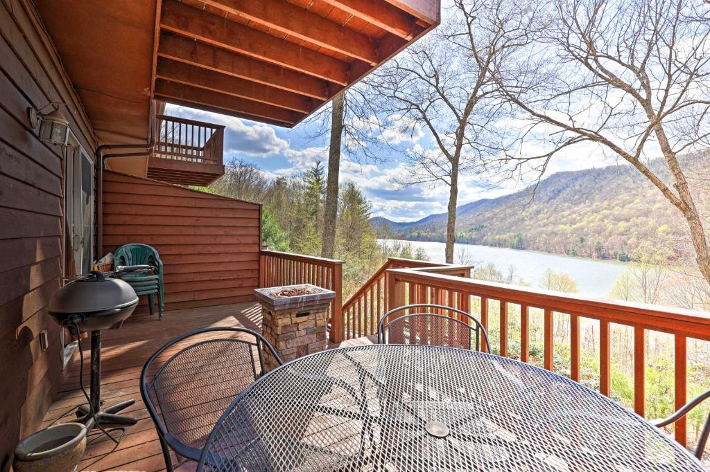 a patio with a table and chairs on a deck at Mountainside Retreat Stunning Watauga Lake Views! in Butler