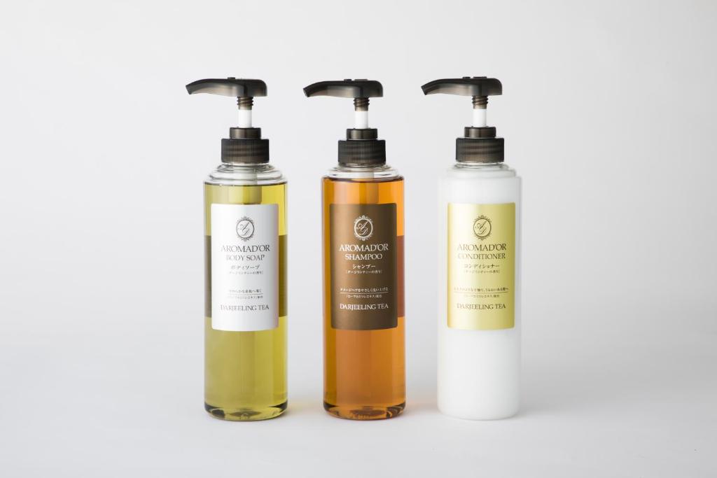 a group of three bottles of liquids on a white background at TUBE Sq in Tokoname