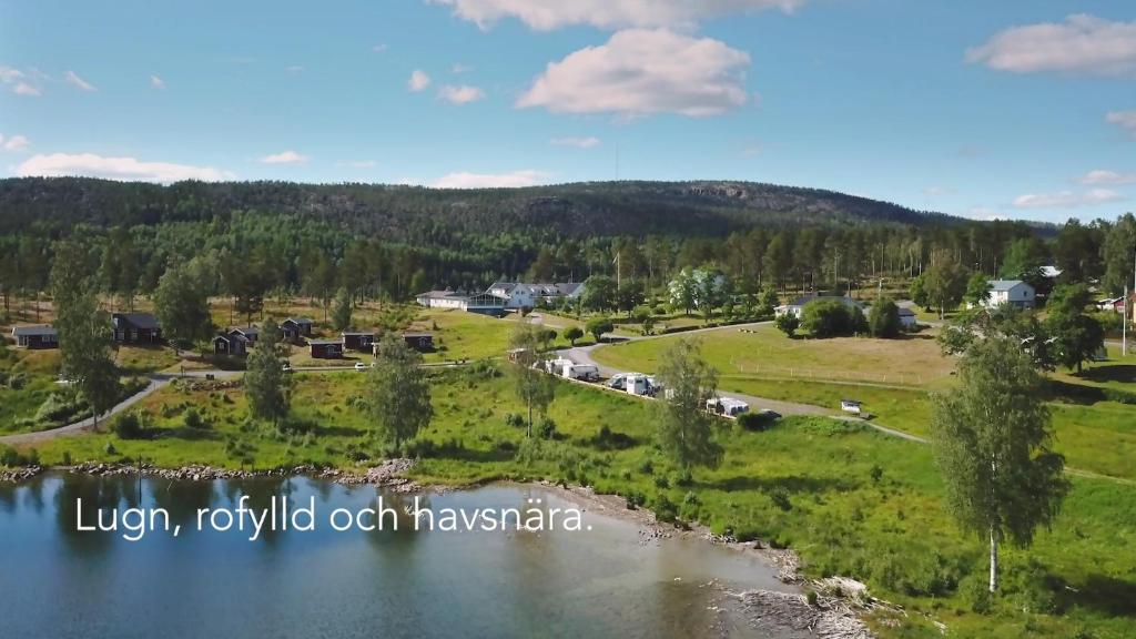 an aerial view of a village and a river at Måvikens Camping in Måviken