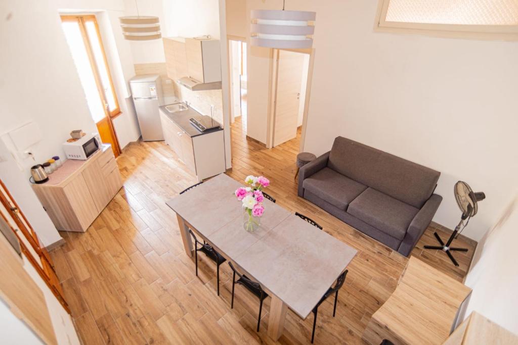 a living room with a table and a couch at Valery Apartments Alghero in Alghero