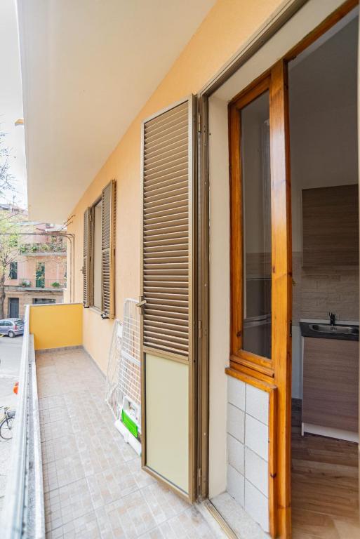 an open door on a building with a balcony at Valery Apartments Alghero in Alghero
