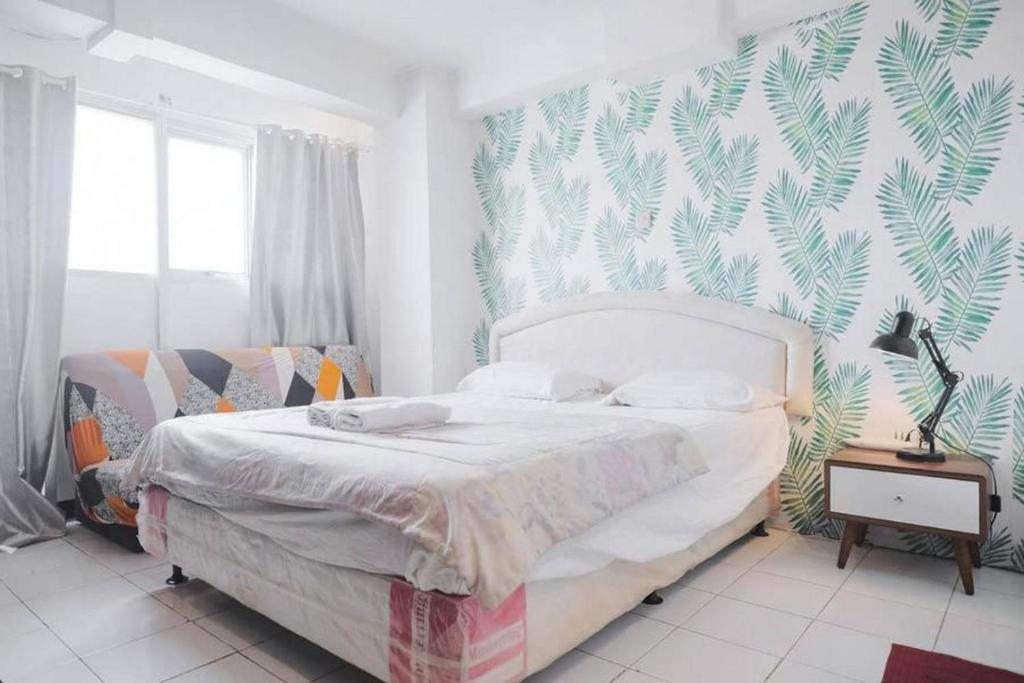 Giường trong phòng chung tại Apartemen Sentra Timur Residence - Cheap Inn Tower Orange