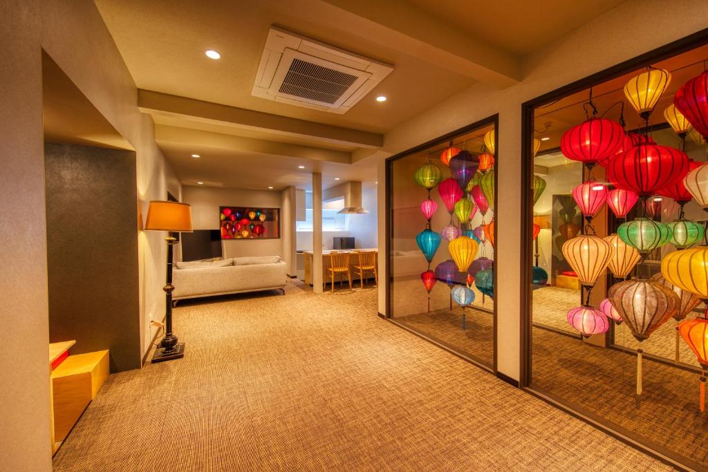 a hallway with a room with colorful lanterns on the wall at ADAN RESORT 灯 - Lamp - in Motobu