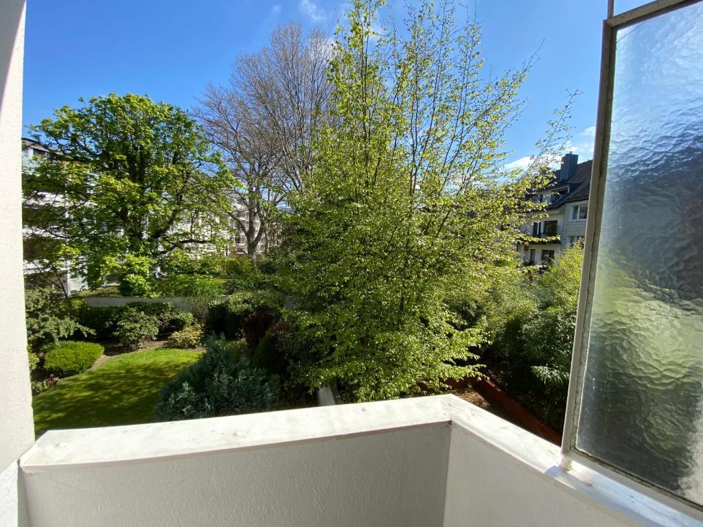a view from the balcony of a house with a tree at Haus am Zoo Apartments verschiedene Adressen in Düsseldorf