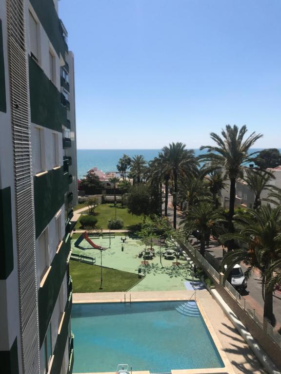 a view of the pool from the balcony of a building at Apartamento residencial Las Palmeras in Benicàssim