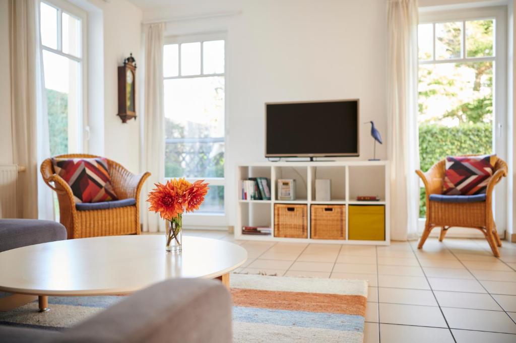 uma sala de estar com uma televisão e uma mesa em Sonneneck Rerik em Rerik
