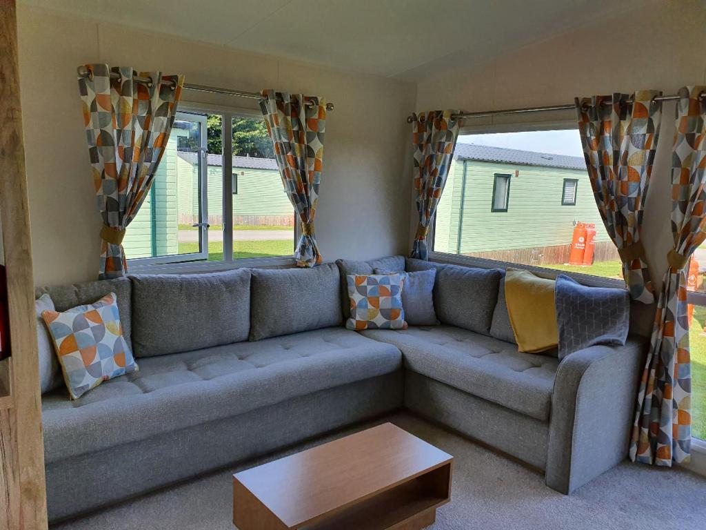 a living room with a couch and a table at Nidd Way Holiday Let in Knaresborough