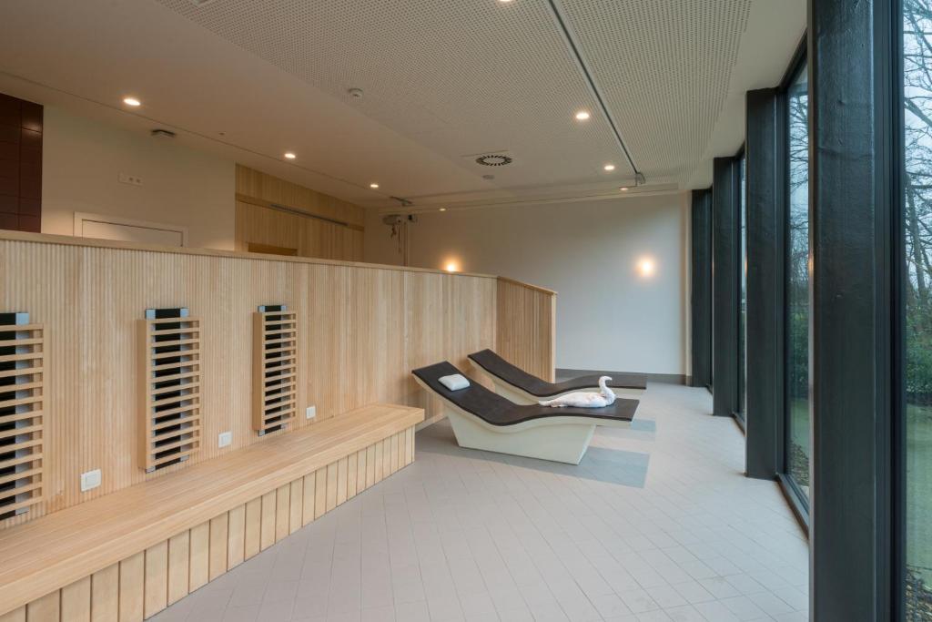 a room with two chairs in a building at Domein Polderwind in Zuienkerke