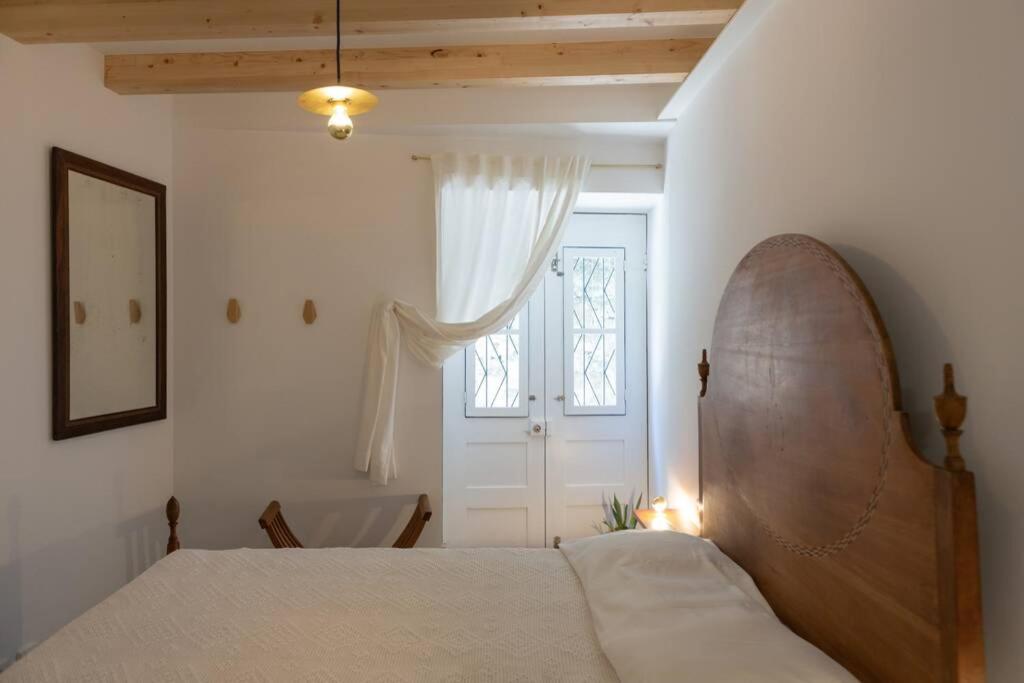 a bedroom with a bed and a window and a tub at Pilgrim suite in Vila do Conde