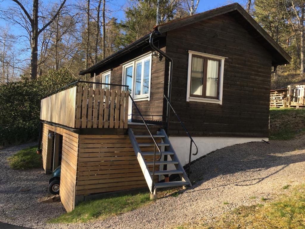 a tiny house with a staircase leading up to it at Lilla Solhaga in Ljungskile
