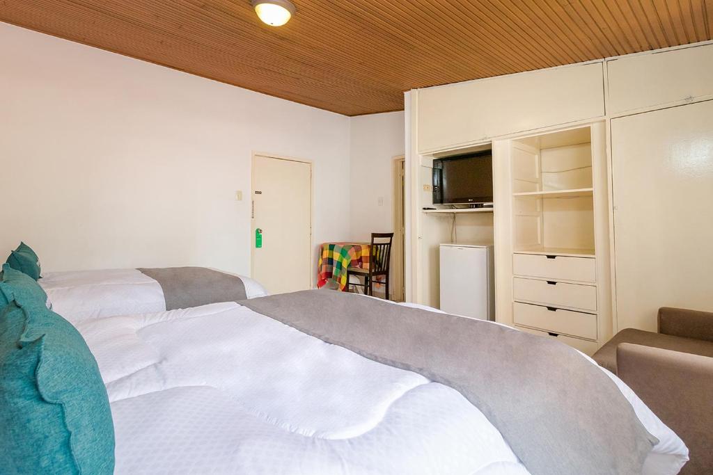 Postel nebo postele na pokoji v ubytování Hotel Calle 112