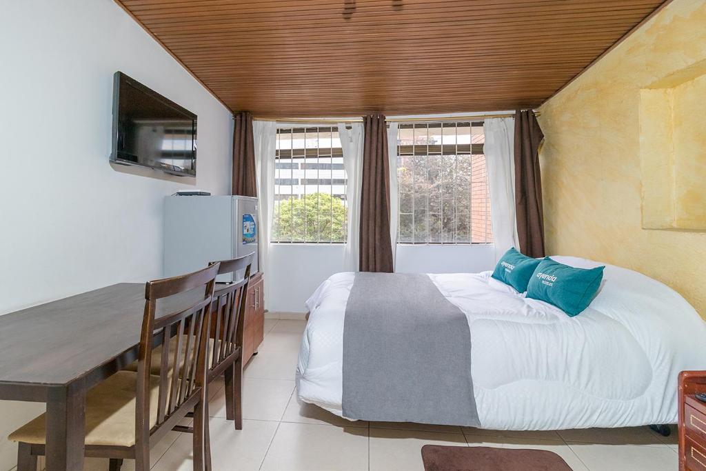 Postel nebo postele na pokoji v ubytování Hotel Calle 112