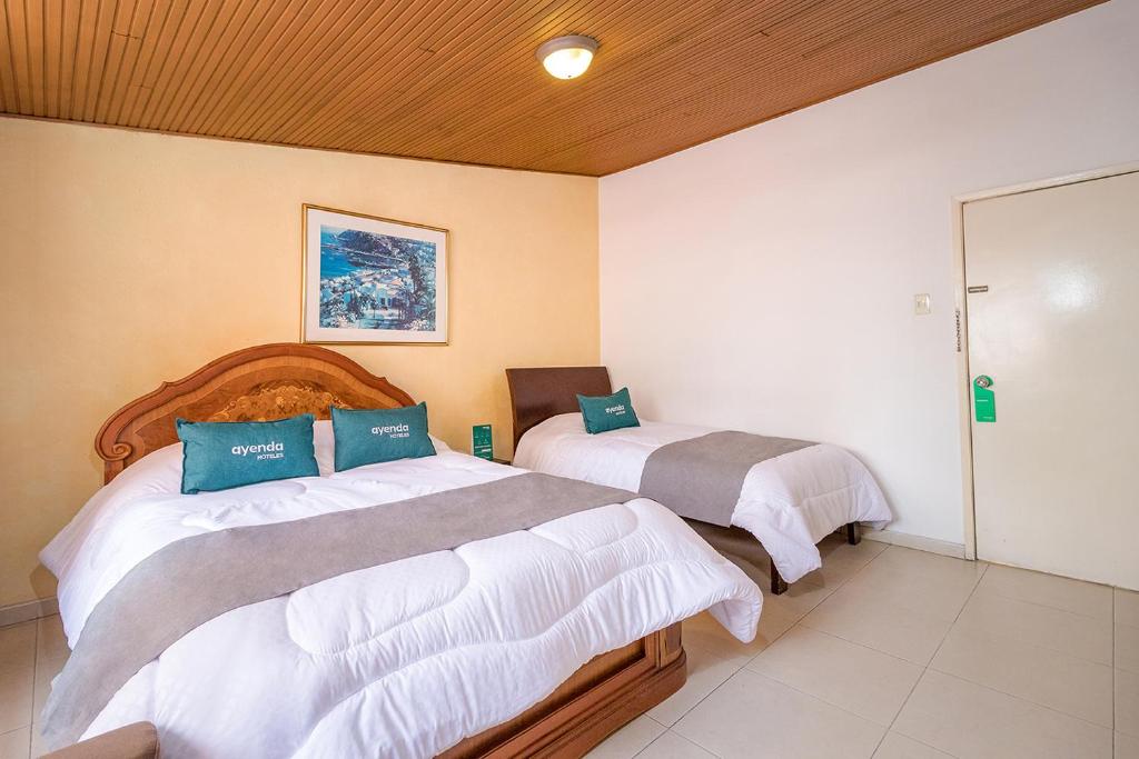 Postel nebo postele na pokoji v ubytování Hotel Calle 112