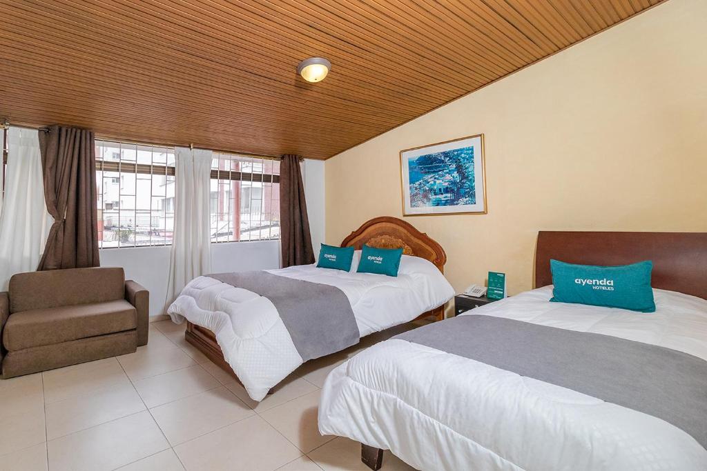 Postel nebo postele na pokoji v ubytování Hotel Calle 112