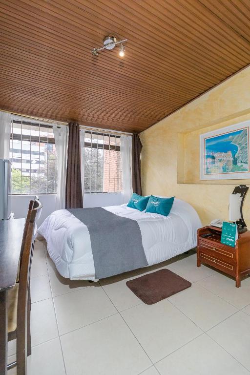 Postel nebo postele na pokoji v ubytování Hotel Calle 112