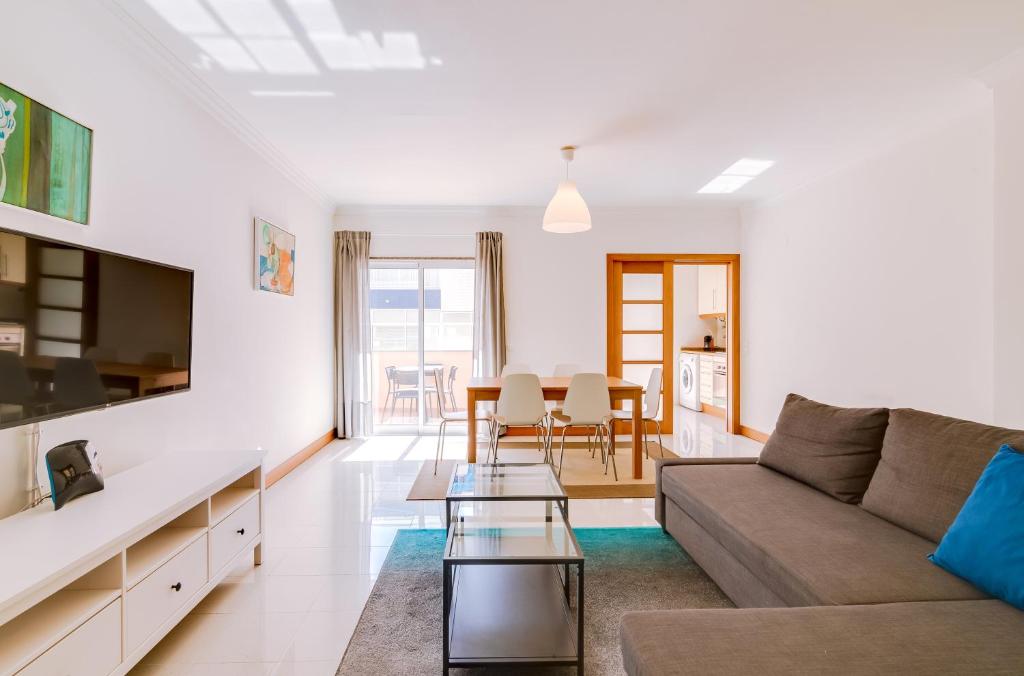 a living room with a couch and a table at AL- Apartamentos Novos Vista Mar in Quarteira