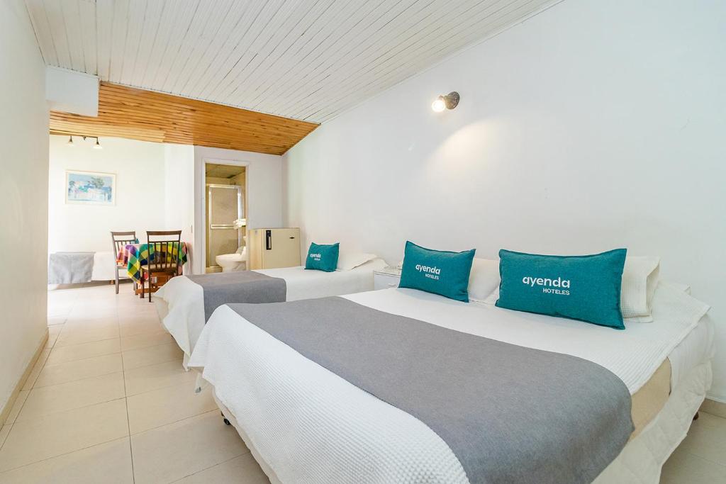 Postel nebo postele na pokoji v ubytování Hotel Calle 112