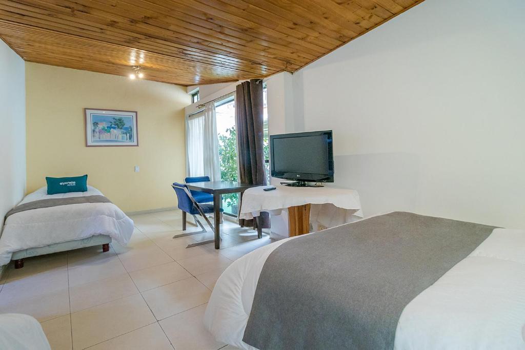 Postel nebo postele na pokoji v ubytování Hotel Calle 112