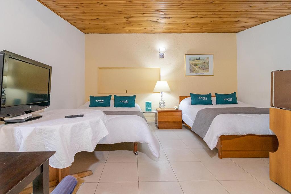Postel nebo postele na pokoji v ubytování Hotel Calle 112