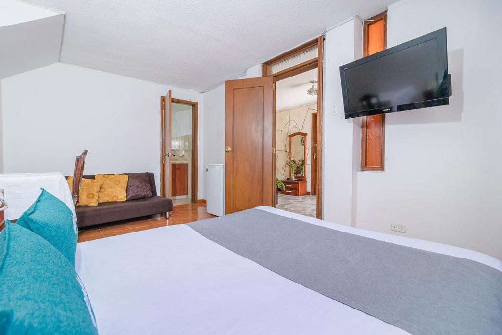 Postel nebo postele na pokoji v ubytování Hotel Calle 112