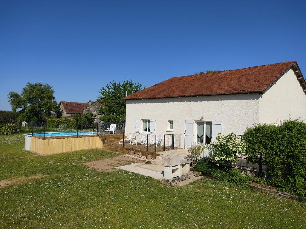 uma casa branca com piscina no quintal em Le Gîte du Moulin à Vent em Plazac