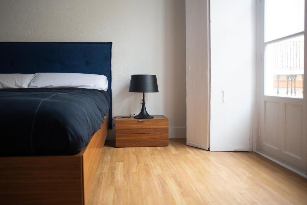 A bed or beds in a room at Casa Plaza de las Flores Cádiz Grupo AC Gestión