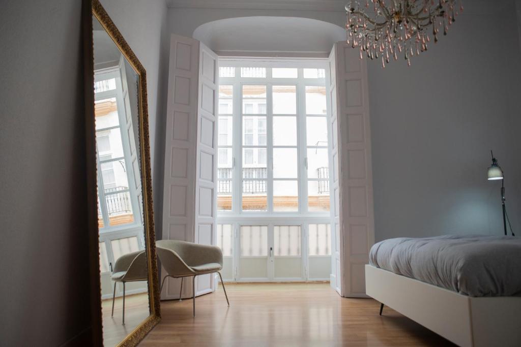 A bed or beds in a room at Casa Plaza de las Flores Cádiz Grupo AC Gestión