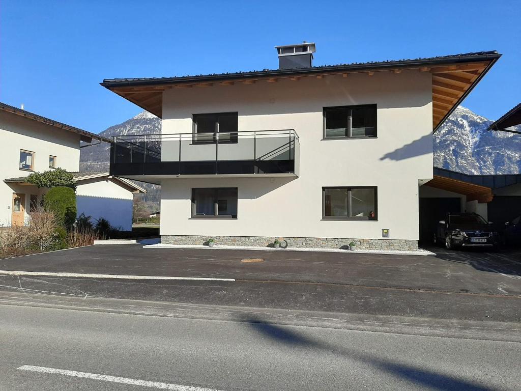 a building with a balcony on the side of a street at Apart Alexandra in Strass im Zillertal