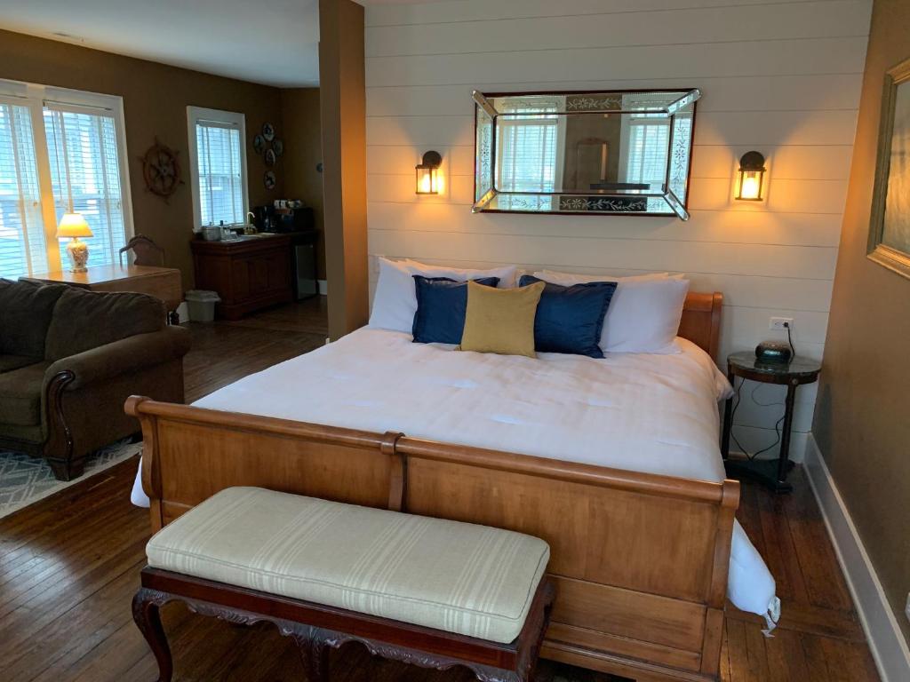 a bedroom with a large bed with blue and white pillows at The Inn at Union Pier in Union Pier