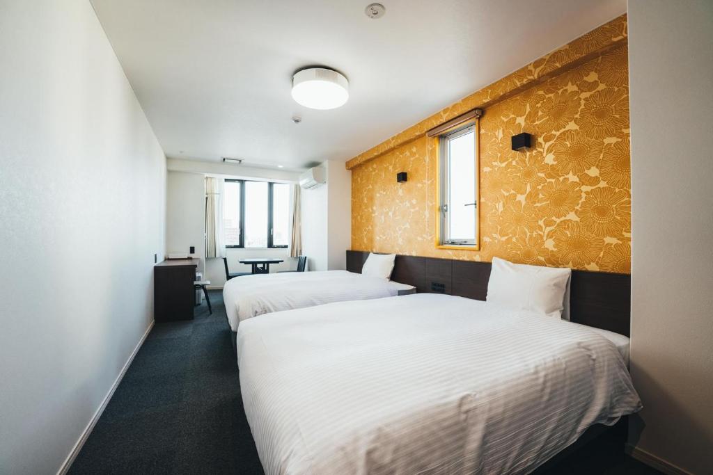 Tempat tidur dalam kamar di TAPSTAY HOTEL - Vacation STAY 35228v