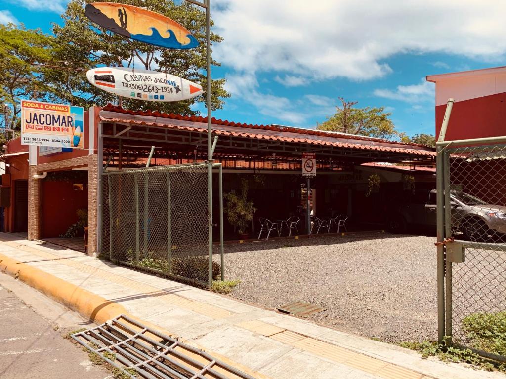 ein Gebäude mit einem Schild für ein Fischrestaurant in der Unterkunft HOTEL Cabinas JACOMAR in Jacó