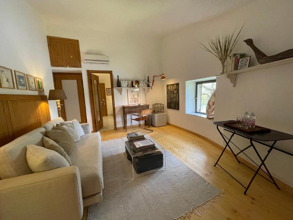 uma sala de estar com um sofá branco e uma mesa em La Finestra sul Fiume em Valeggio sul Mincio