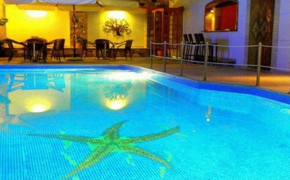 a large blue swimming pool in a hotel at Nefeli Hotel in Karlovasi
