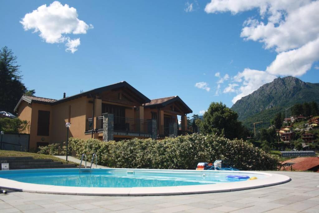 a large swimming pool in front of a house at Piscina e vistalago CroceMenaggio CIR 013145-00318 in Menaggio