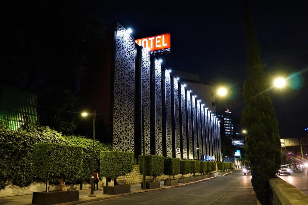 a lit up building with a will sign on it at night at Hotel Principe in Mexico City