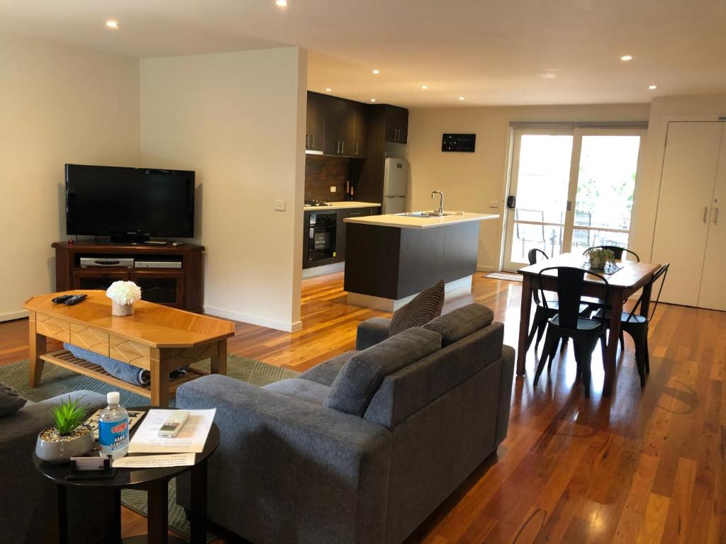 a living room with a couch and a table at Chill Apartment in Rye