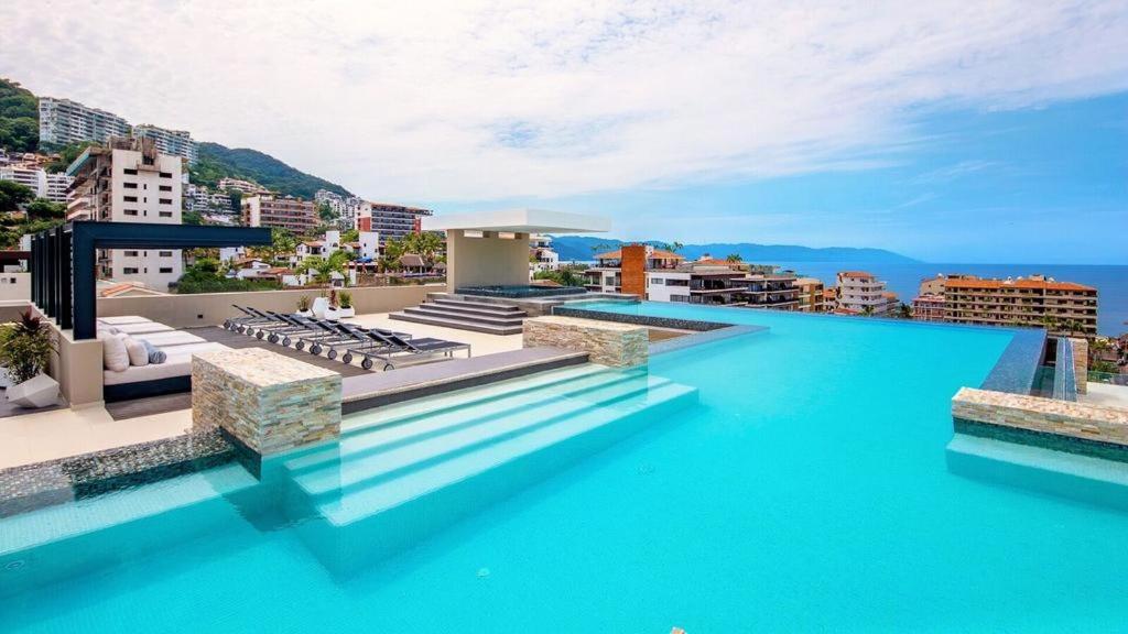 a swimming pool with blue water on top of a building at Condominio Loft 268 Zona Romántica Departamento 510 in Puerto Vallarta