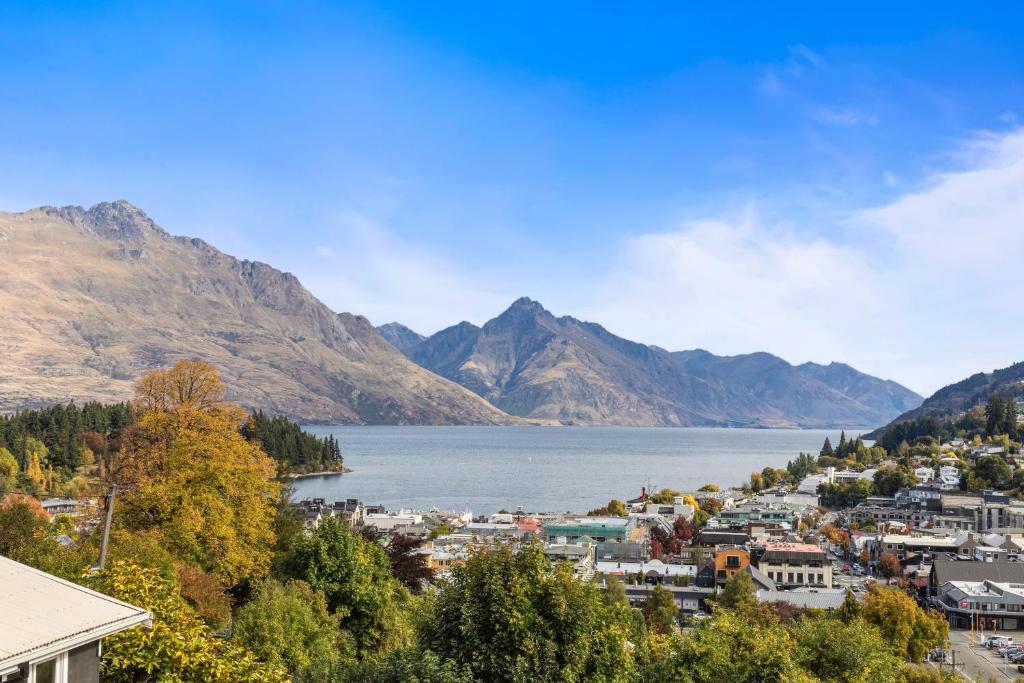a view of a town next to a body of water at Queenstown House Bed & Breakfast and Apartments in Queenstown